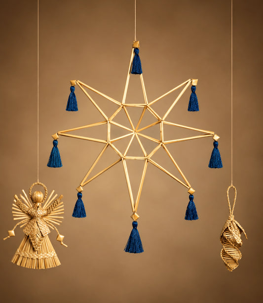 A hanging gold-toned star ornament with blue tassels, shown against a warm brown background. Smaller hanging ornaments in gold tones are visible at the lower left and lower right.
